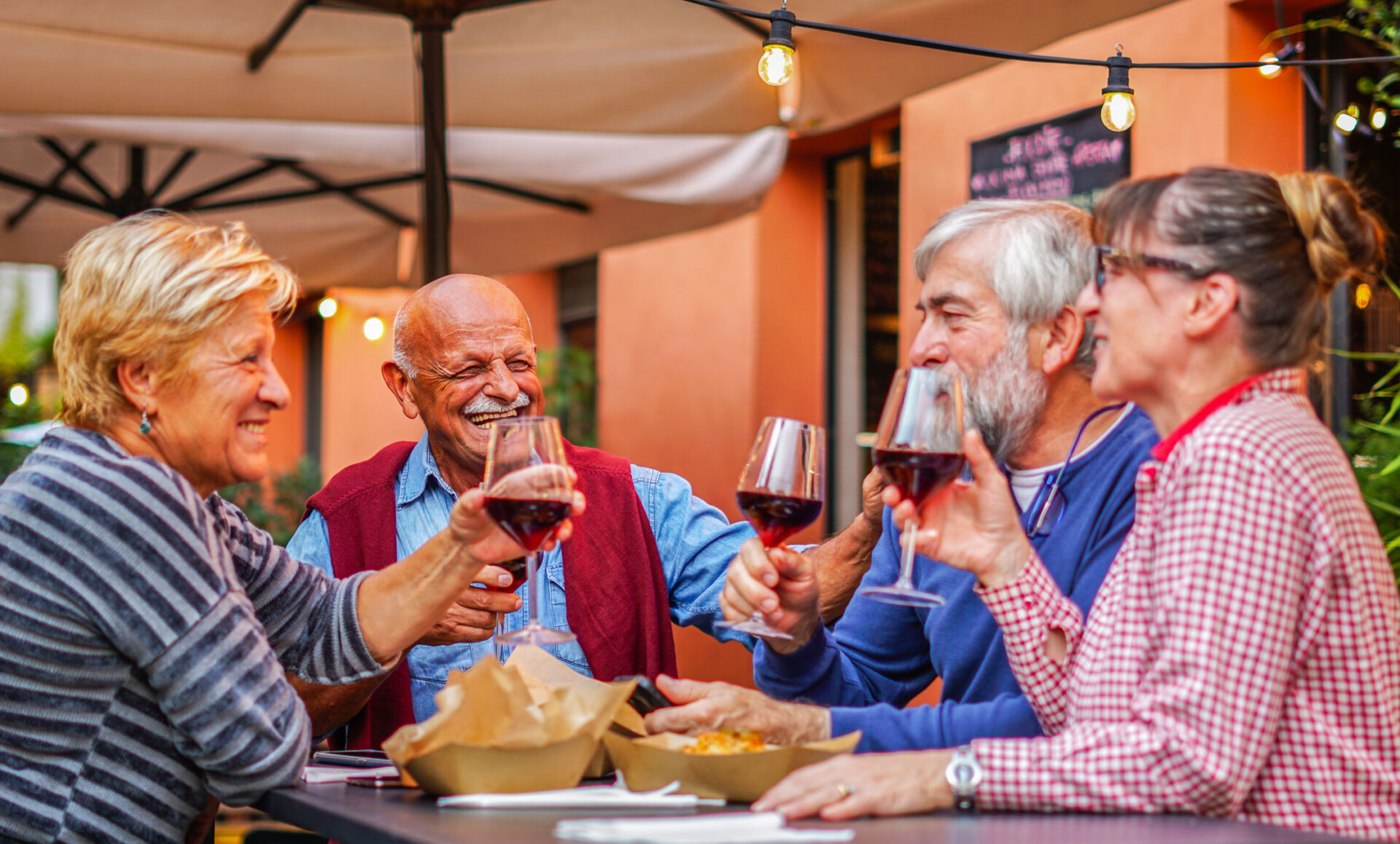 Group of old people eating and drinking outdoor - Senior couples having fun together